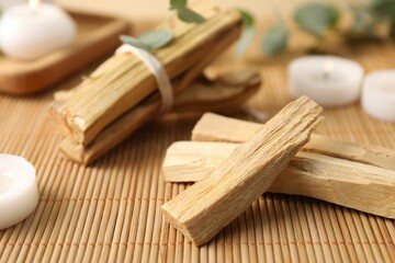 Palo santo sticks on bamboo mat, closeup