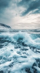 Dramatic stormy ocean waves crashing against a snowy rocky cliffside under an ominous cloudy sky  Powerful and moody seascape with a sense of energy and force