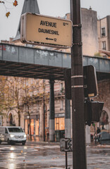 Avenue Daumesnil under rain showcasing urban life in a busy Paris street