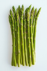 Bunch of green asparagus are displayed on a white counter