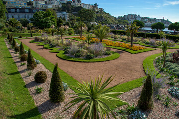 Italian gardens at Torre Abbey Park and meadows. Landmark tourist attraction Tropical palms,...
