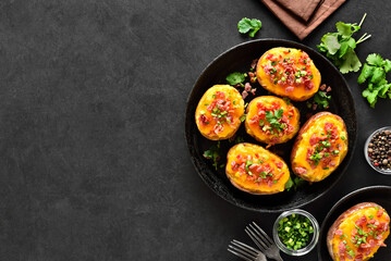 Baked stuffed potatoes with bacon, green onion and cheddar cheese