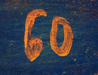 Neon number 60 on blue textured background. Sixty