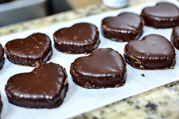 Heart-shaped chocolates on parchment paper
