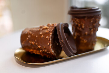 Chocolate Cups with Nut Coating on a Golden Tray, Close-Up