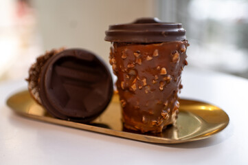 Chocolate Cups with Nut Coating Served on a Golden Tray