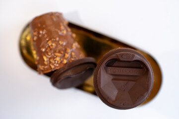 Top View of Chocolate Cups with Nut Coating on a Golden Tray