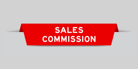 Red color inserted label with word sales commission on gray background