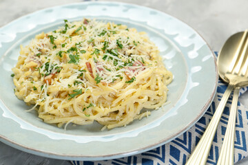 Delicious pasta Carbonara with bacon served on gray table, closeup