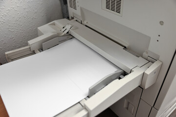 Modern printer with paper indoors, closeup. Printing house