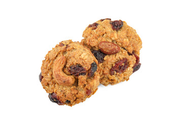 Delicious oatmeal cookies with dried cranberries and nuts isolated on white, top view