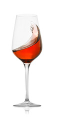 Rose wine splashing in glass on white background