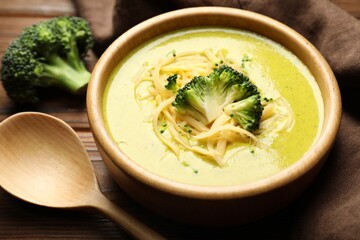 Delicious broccoli cream soup served on table, closeup