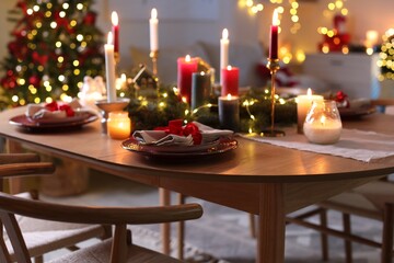 Festive table setting in room decorated for Christmas. Bokeh effect