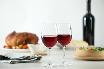 Red wine and delicious dinner served on light table