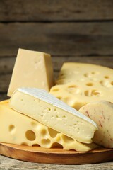 Different types of cheese on wooden table, closeup