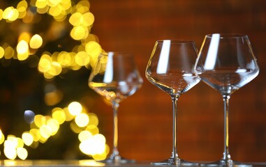 Wine glasses on table against blurred lights. Bokeh effect