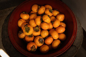 Top view of the bowl with fresh persimmon