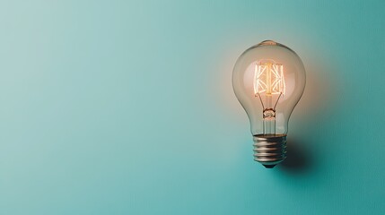 Creative technology concept with a light bulb incorporating mechanical gears, glowing on a clean blue background with ample mockup space.