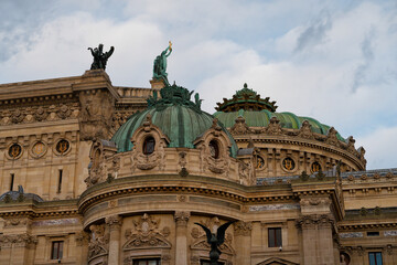Historic architectural detail of an ornate building highlighting its distinctive domes and sculptures under a cloudy sky