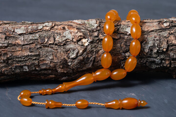 Macro detail shot of Ottoman tightened amber rosary. Old amber on a tree branch.
