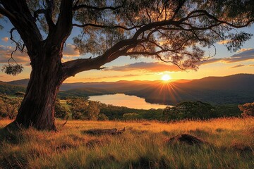 Fototapeta premium Golden Sunset over Serene Lake and Mountains: Nature's Peaceful Panorama, Breathtaking View from Hilltop