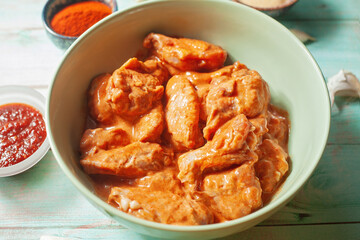Close-up of raw marinated chicken wings, food preparation