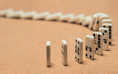 domino pieces lined up falling sequentially.