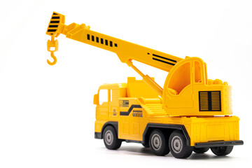 Naklejka premium toy truck crane isolated on white background. Construction industrial equipment for transporting materials. Plastic child toy on white backdrop. Construction vehicle. Children's toy. Crane Toy.
