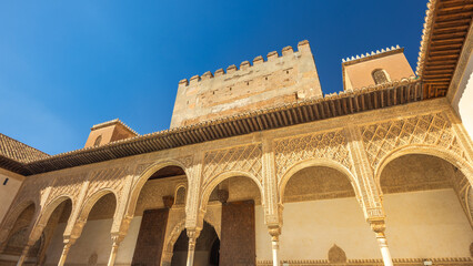 The Court of the Myrtles, the central courtyard of the Comares Palace at the Alhambra complex in Granada town, Andalusia, Spain. Ornate arches and intricate details of a historic courtyard.