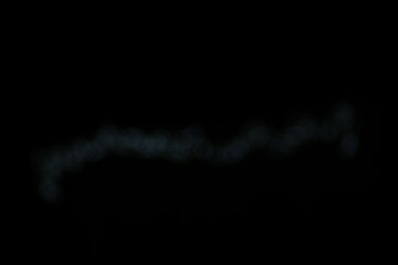 Christmas lights in bokeh. Outside in December. Silver and white bokeh on a black background, bokeh abstract background, Christmas lights bokeh in line background. Orange Christmas background, Xmas
