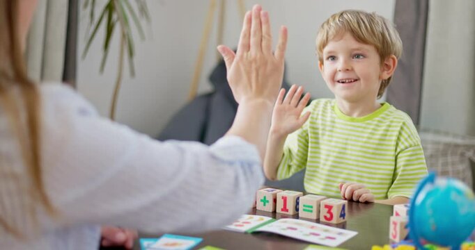 Happy child high-fiving during learning activity
