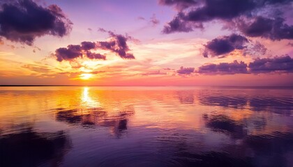 Obraz premium purple sunset at sea water mirrored image sun mild on gold yellow clouds sky nature background