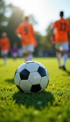 Fototapeta premium A vibrant scene of a soccer ball in focus, surrounded by players in orange jerseys, evoking the excitement and energy of the game.