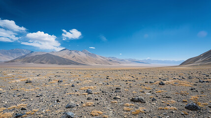 A high-altitude desert with colorful striated rock formations under a vast, clear sky.