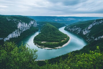 Stunning river winding through lush green hills under a cloudy sky in a remote natural setting