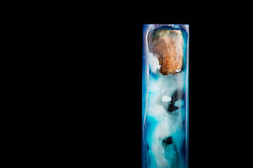 Artistic Resin Pendant Featuring Earthy Wood and Ethereal Blue Swirls.