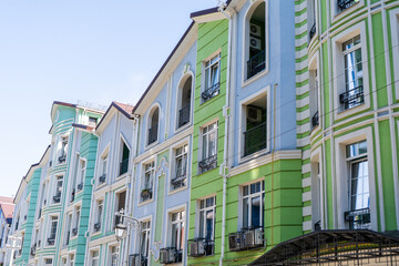 Multicolor modern exterior of Houses Buildings facade. Bright architecture. Balconies and windows green blue color