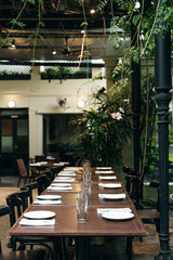 tableware Glasses, flower fork, knife served for dinner in restaurant with cozy interior