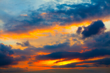 Majestic sunset with dramatic dark clouds on vibrant sky. Breathtaking stormy heaven with twilight