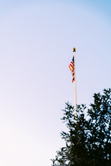 American Flag on a tall pole against a blue sky