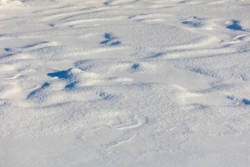 The snow is white and the ground is covered in it