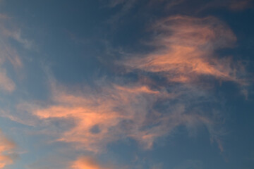 Whispers of pastel clouds dance across the twilight sky