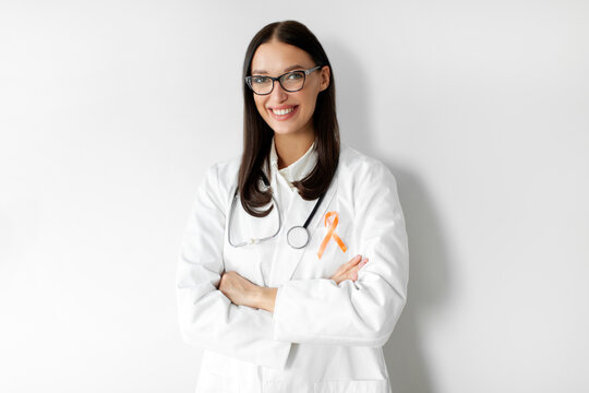 Woman doctor with orange ribbon, symbol of Leukemia, Kidney cancer, world Multiple Sclerosis, CRPS, Self Injury Awareness month - Powered by Adobe