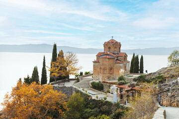 Charming St. John church at Kaneo, perched above the Ohrid lake, surrounded by colorful autumn...