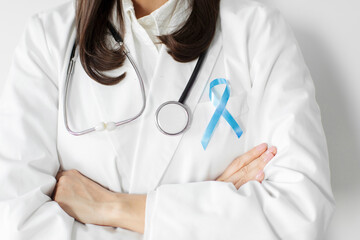 Prostate cancer awareness. Female doctor with blue ribbon for support people life and illness, closeup cropped shot. World cancer day