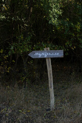 Wooden sign in the forest. Boguchar village.