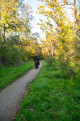 A person riding a motorcycle down a dirt road