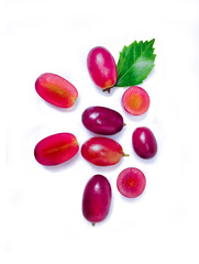 Red grapes and half sliced with green leaf isolated on white background. Top view.