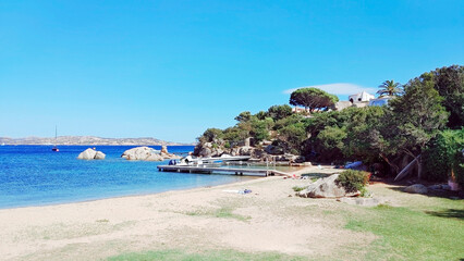 Jetty and beach of the village in front of Maddalena archipelago. Hamlet of Porto Rafael, Palau, Sassari, Sardinia Island, (Sardegna), Italy.